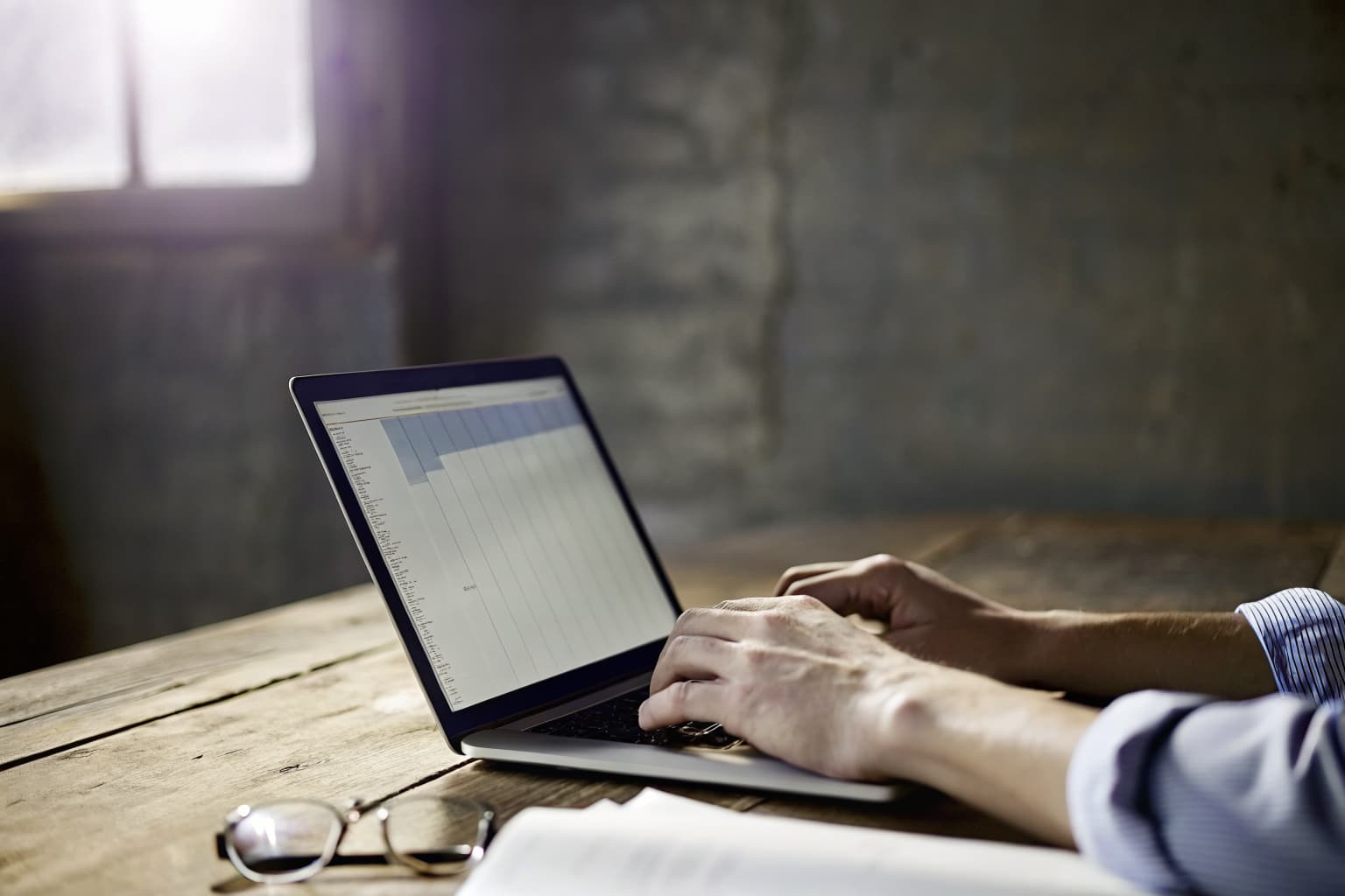 Small business owner reviewing a marketing cost comparison on a laptop